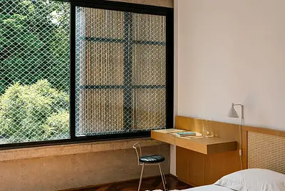 Casa de vidro iluminada com muito verde